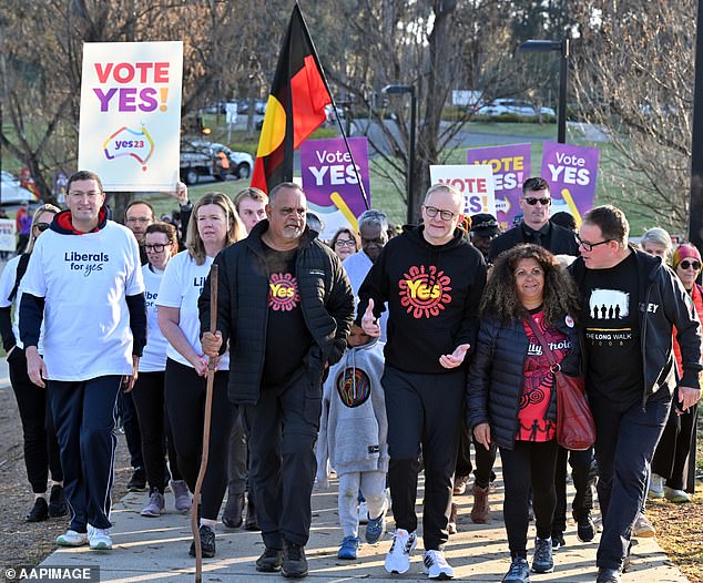 Prime Minister Anthony Albanese and former AFL player Michael Long walk to Parliament House at the completion of his 20-day walk for the Yes vote in Canberra earlier this month
