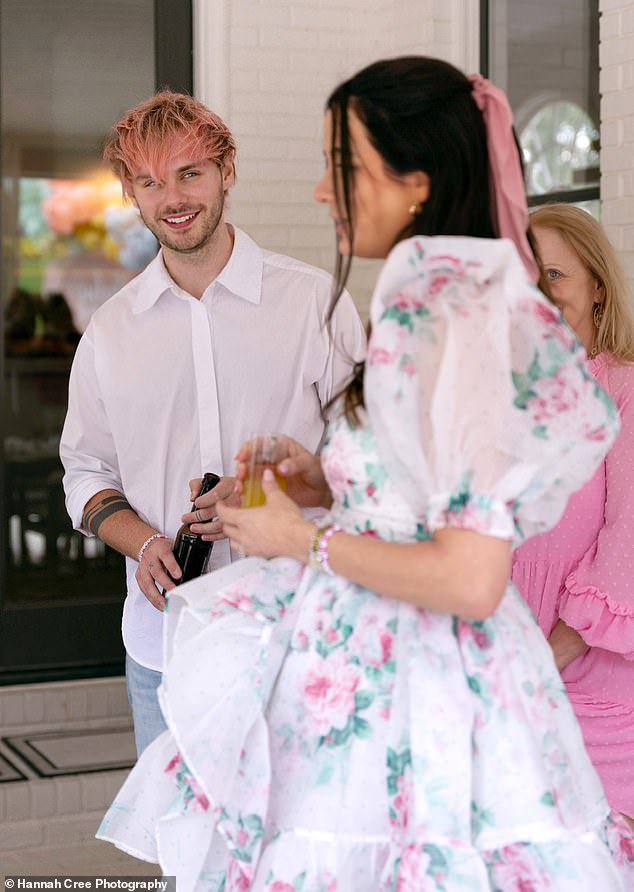 The brunette beauty swept her long locks back into a half updo, secured in the back with a pink bow as she left a few face-framing pieces loose