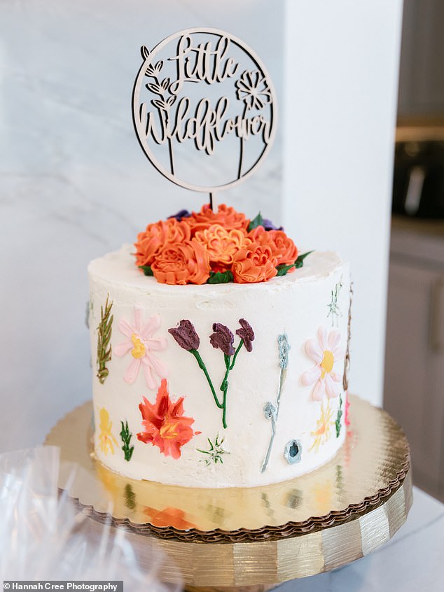 A beautiful white cake covered in wildflower decorations was served alongside a huge array of snacks