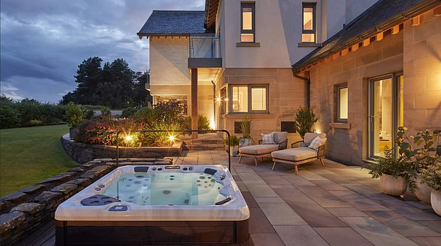 The spectacular six-bedroom home in Scotland has a breathtaking backdrop of the Ochil Hills, which residents can gaze upon from the luxury of their own hot tub