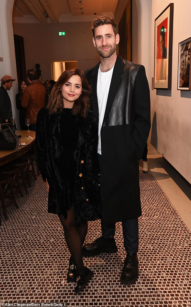 Stunner: She posed next to her on-screen husband, who towered over her as he looked trendy in a long black coat with leather inserts