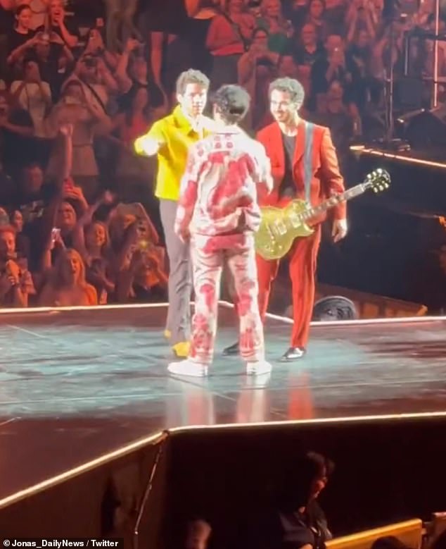 Supportive: Joe got an onstage hug from his brothers Kevin, 35, and Nick, 30, before his show in Arizona after making a statement that he is getting a divorce