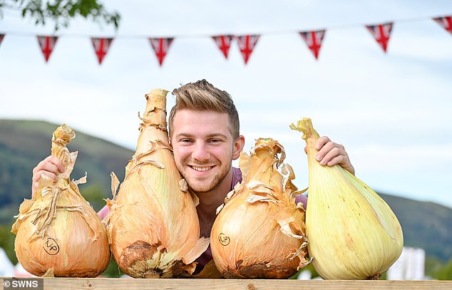 Gardeners have put their oversized vegetables on display - from giant pumpkins to cucumbers over 100cm long - at the Three Counties Showground