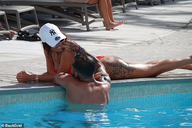 In love: Chloe was caught packing on the PDA with her on and off beau Johnny Wilbo as the duo looked smitten while chilling by the pool