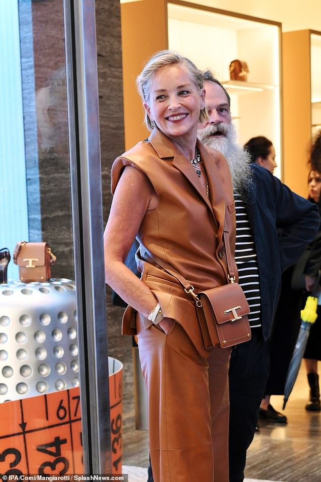 Grinning: The Basic Instinct actress completed her look with leather wrap bracelets and a simple crossbody bag from the brand