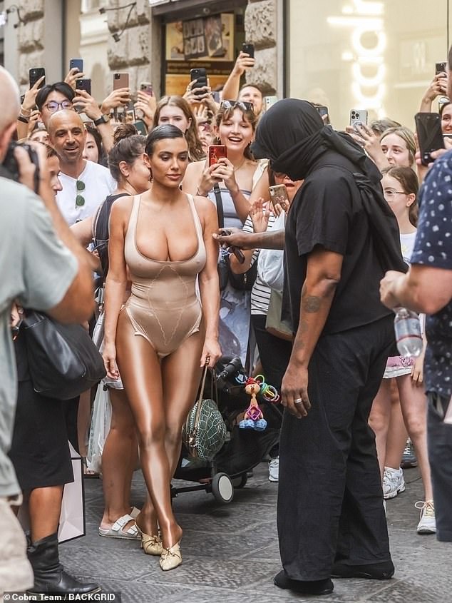 Madness: Just hours earlier, Kanye and his new 'wife' Bianca caused a frenzy while shopping in Florence's Via dei Calzaiuoli on Thursday.