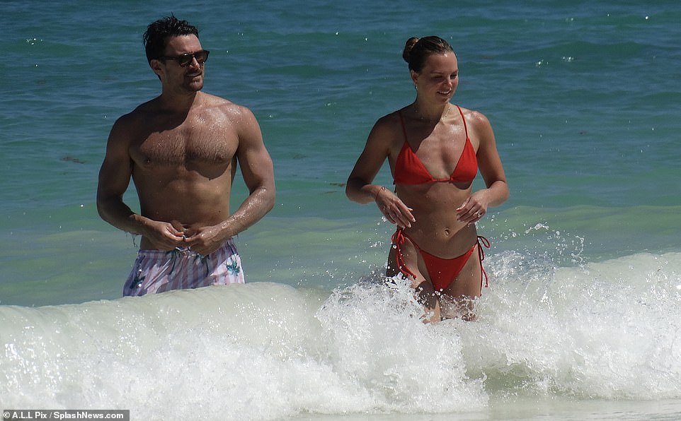 Fun in the ocean: The Better Tomorrow podcast host looked stunning in a tiny red bikini as she enjoyed the day with her future husband