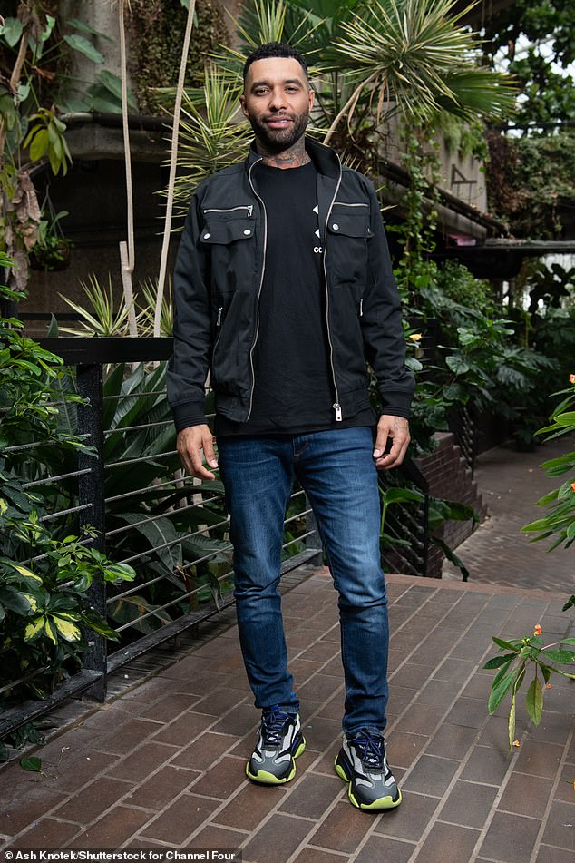 Laidback: Former footballer Jermaine looks casual in a black T-shirt, matching zip-up jacket and blue jeans