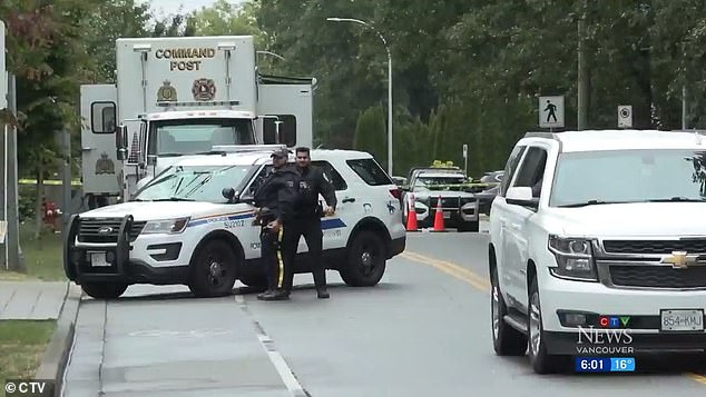 Police are seen at the scene of the murder, which took place near a Sikh temple