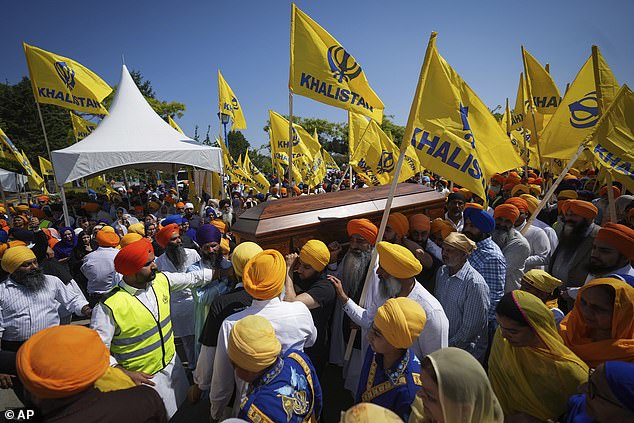 Mourners carry the casket of Sikh community leader and temple president Hardeep Singh Nijjar during Antim Darshan, the first part of a day-long funeral service for him, in Surrey, B.C.