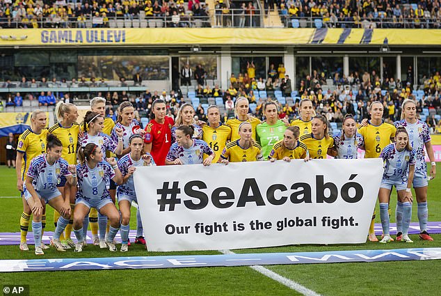 Before Spain's match against Sweden, both groups of players posed with a banner of solidarity