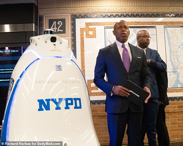 New York Mayor Eric Adams is pictured above with his new Robocop introducing the machine at the Times Square subway station