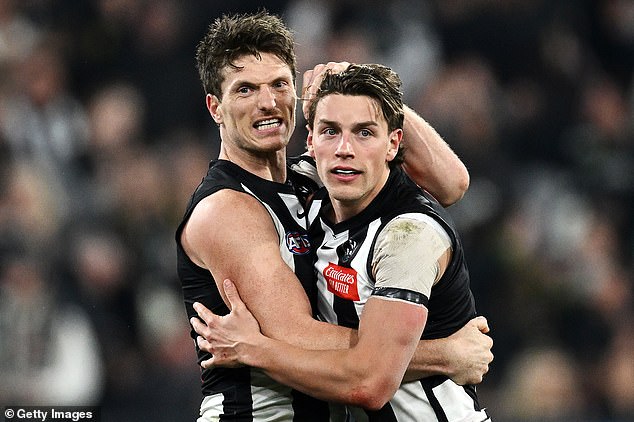 Mihocek celebrates with Patrick Lipinski as the Magpies prepare for a record AFL/VFL premiership