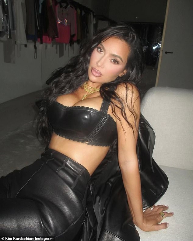 Beautiful lady: For her second look, Kim opted for a low-cut black latex crop top, which exposed her ample cleavage