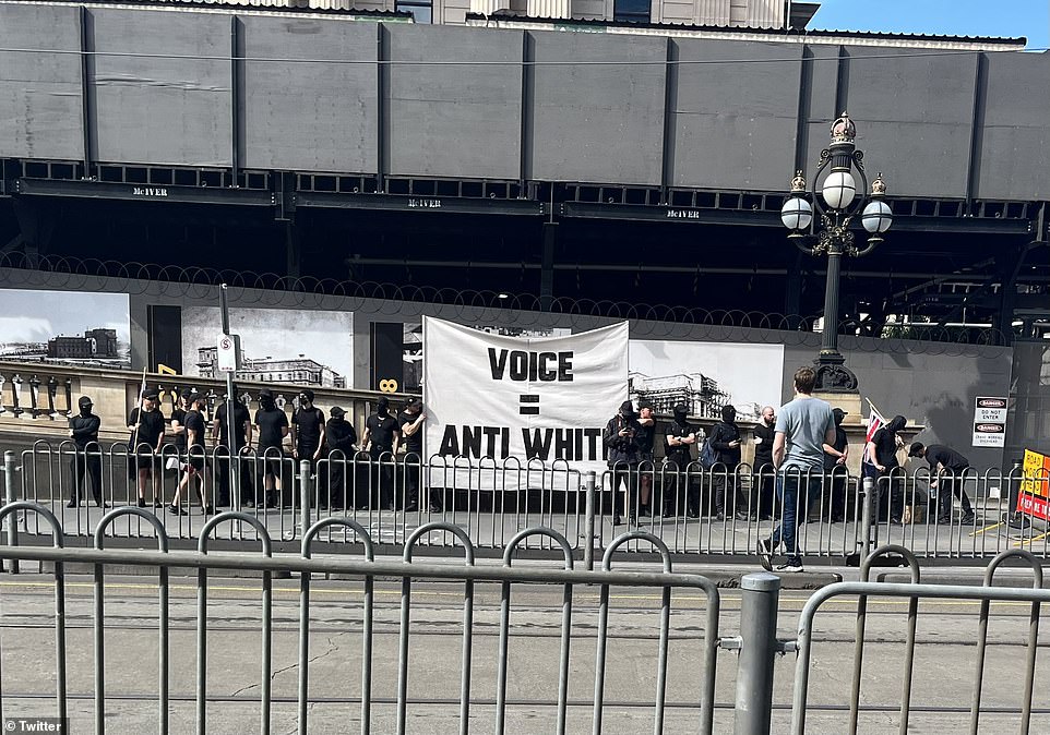 The meeting in Melbourne also included a group dressed in army uniforms, holding up a banner reading 'Voice = anti-white'