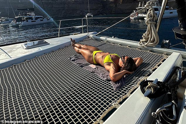 Showcasing her toned abs, the film opened with an image of the football legend relaxing on a boat as she donned a bright yellow two-piece and soaked up the sun.