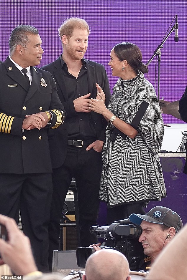 The Duchess beams at Prince Harry as they are introduced as special guests