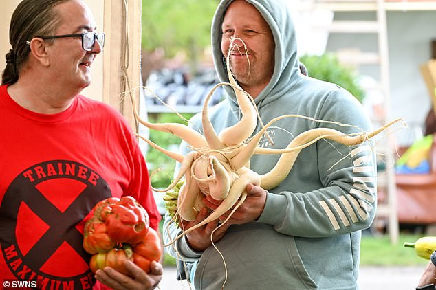 Gardeners have put their oversized vegetables on display - from giant pumpkins to enormous radishes - at the Three Counties Showground