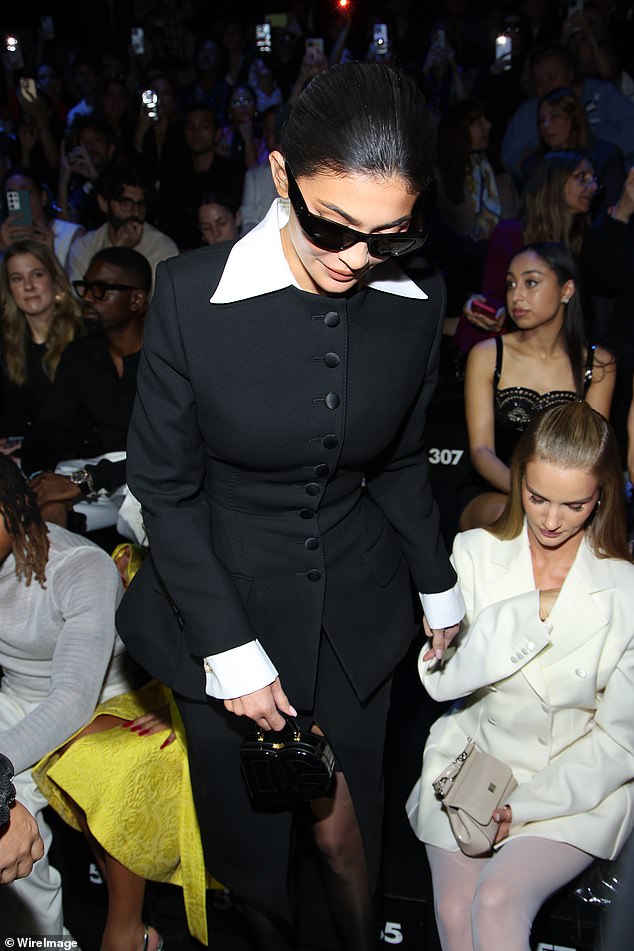 Sensational: TV personality Kylie, 26, looked glamorous in a black button-up mini dress with white collar as she sat front row