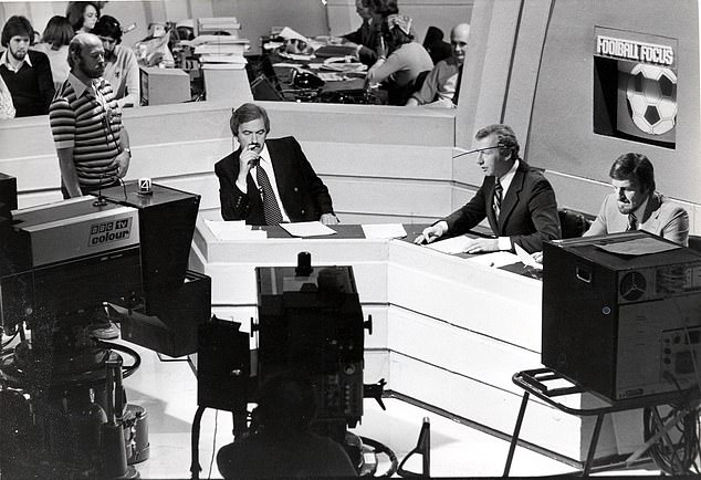 Des Lynam (left) listens in as Bob Wilson and Jimmy Hill run Football Focus in 1979