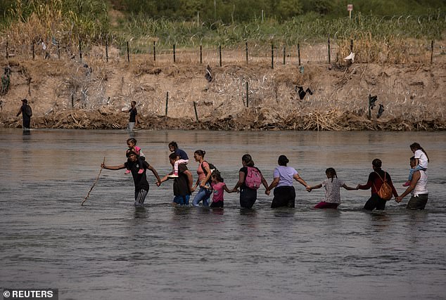 Migrants were photographed wading across the Rio Grande from Piedras Negras to Eagle Pass last week