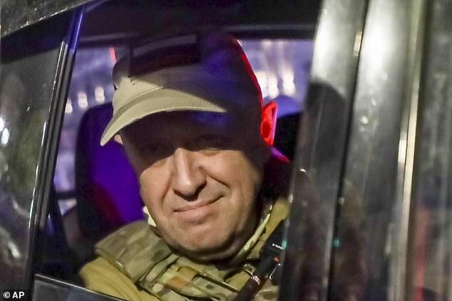 Yevgeny Prigozhin, head of private military contractor Wagner Group, looks from a military vehicle before his death in June