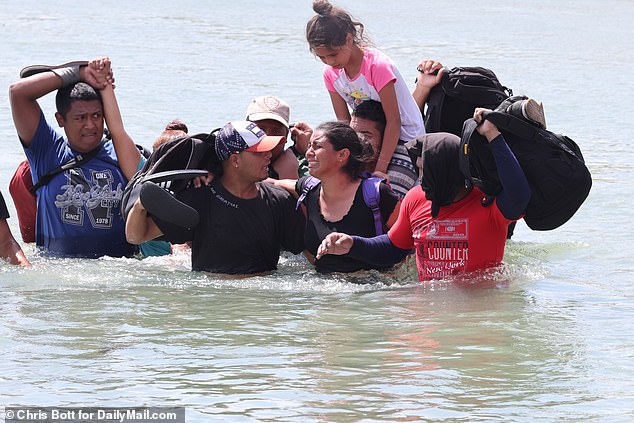 Exclusive footage from DailyMail.com shows small family groups making the perilous crossing from Piedras Negras on the Mexican side - with a Venezuelan mother seen sobbing as she wades through waist-deep water