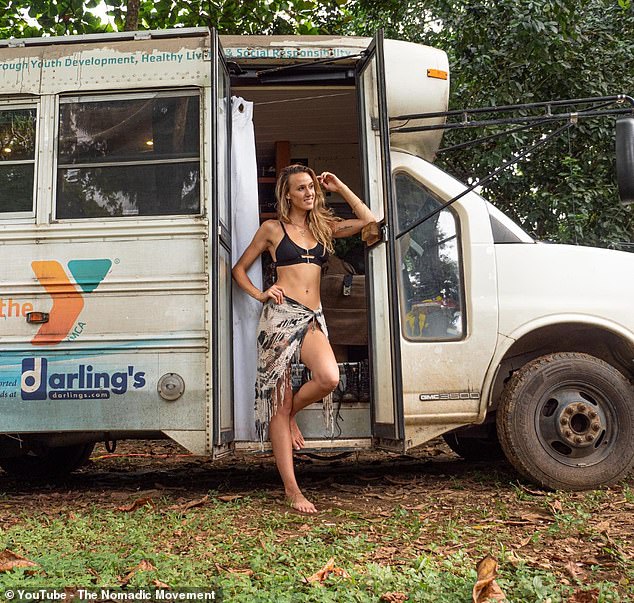 Kaylee poses next to their beloved school bus, which served as their home for years