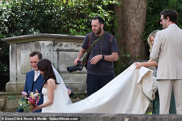 Michelle's beautiful dress was held up as the newlyweds left the ceremony earlier today