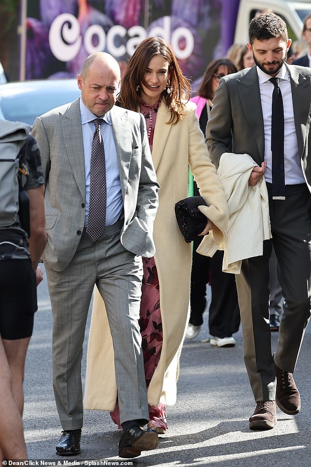 Actress Lily James (pictured) wore a long lemon-colored coat at the wedding in London today