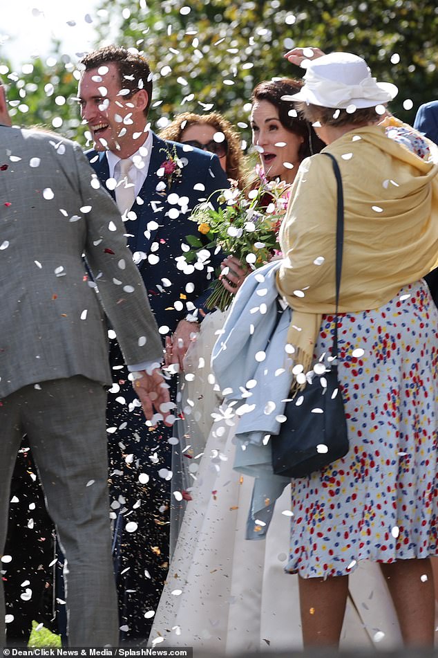 The newlyweds were showered in confetti as they left the church in Chiswick, London