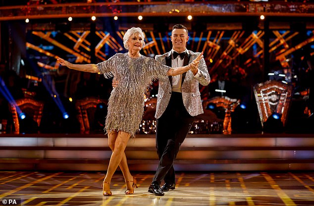 Sensational: Angela looked sensational in a silver fringe mini dress as she performed on Shirley Bassey's cover of Pink's Get The Party Started before kicking her partner and lifting her leg for the dramatic finale