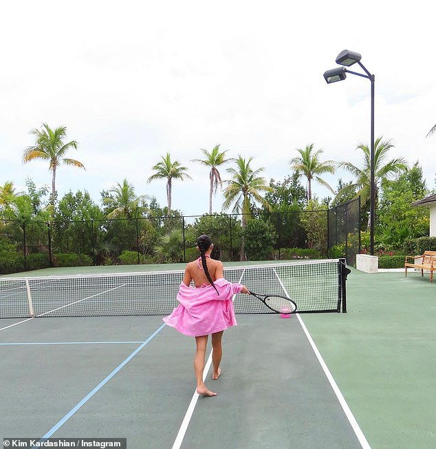 Barefoot: She shared two photos of her bare feet on the tennis court, with her body oiled to show off to maximum effect