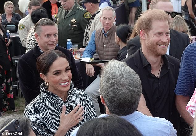 She kept her hair pinned up and added a touch of glamor to the look with a pair of gold hoop earrings and a simple gold watch.