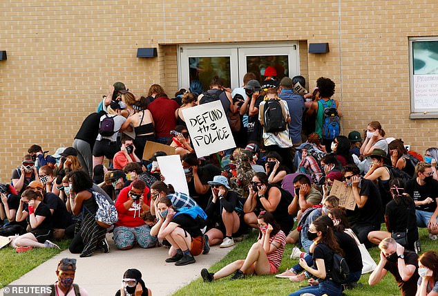 Protesters, pictured in July 2020, block an exit to the police station of the officers who arrested McClain