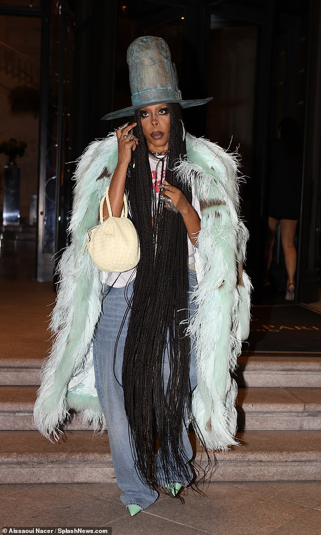 Notable: American rapper and singer Erykah Badu, 52, made a statement with her look as she donned an elaborate top hat and feathered white and mint green coat