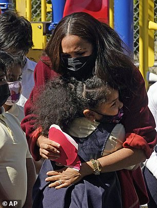 Meghan Markle hugs children at the Harlem school during the September 2021 visit where she read her book