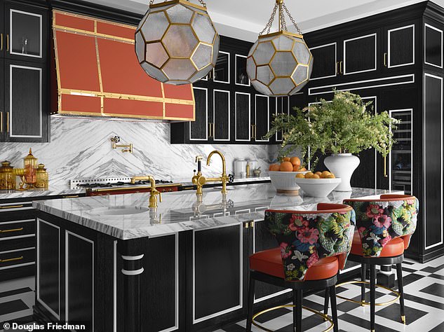 An orange Château range from lacornue.com crowns the kitchen at duchateau.com.  Hexsation lanterns from Corbett remind RuPaul of old-fashioned diving helmets