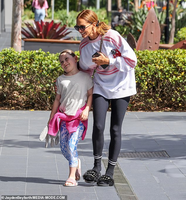 The interior design guru, 42, rocked a white and pink striped sweater paired with black leggings and unusual fluffy slippers