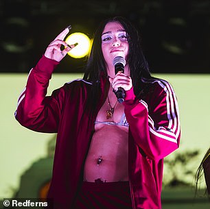 Dazzling diamond: She also wore a dangling diamond belly ring and an extensive collection of small tattoos that adorned her body as she performed