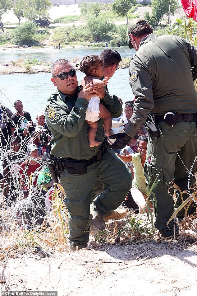 Some babies were carried by National Guard and Border Patrol personnel, who took the babies from their exhausted mothers as they struggled up the bank.