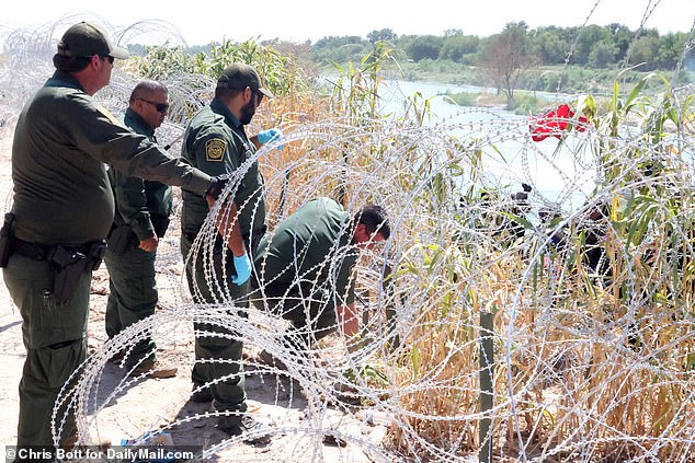 After nearly four hours in the river and on the bank, the guards were finally forced to cut the barbed wire and allow the group through due to concerns for their well-being.