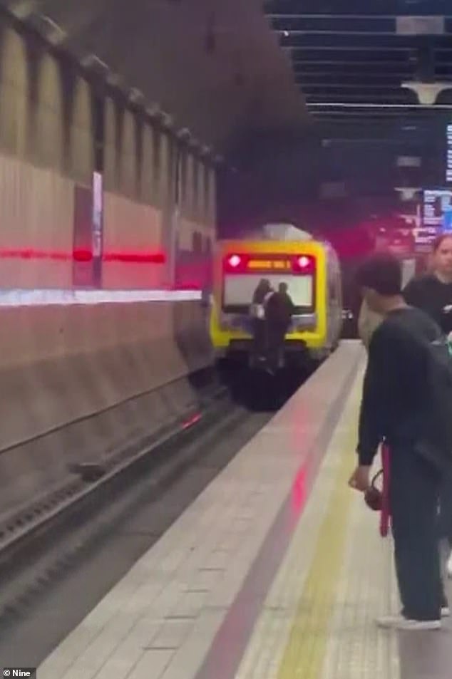 The cheeky couple even waved at the camera as the train left an underground station in Melbourne