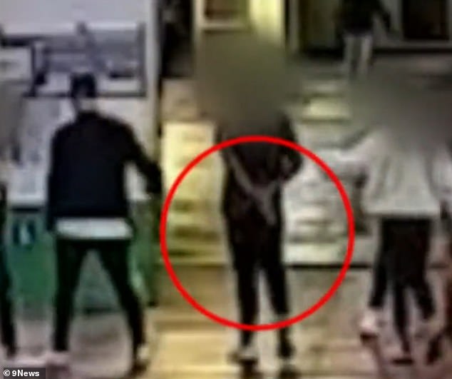 Danny's attacker (pictured in the red circle next to Danny just before he pushed him in the head) was charged with a violent crime last week after being released from detention last May