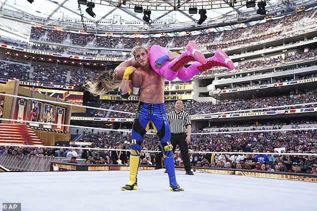 Here, Paul is pictured pinning down WWE titan Seth Rollins at WrestleMania 39 in April