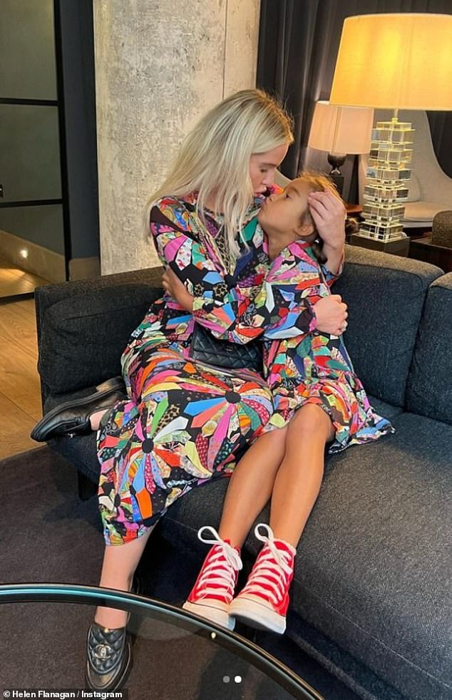 Adorable: The 33-year-old posted a photo of her and her eldest cuddling up close as they donned matching multi-colored patterned dresses