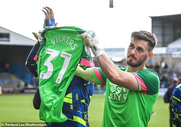 Vickers' teammates held up his shirt as a show of support as he was absent from yesterday's game