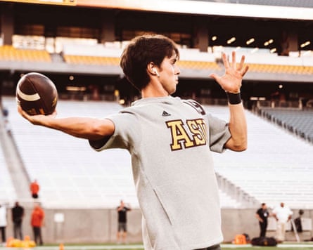 young man with soccer ball in a stadium about to throw it