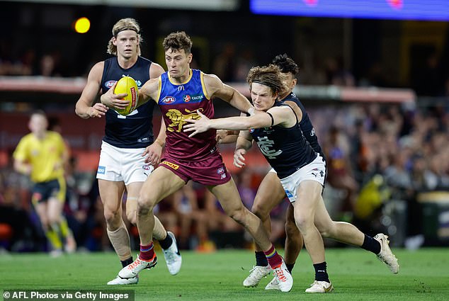 Josh Dunkley of the Lions is tackled by Jordan Boyd of the Blues during the second AFL preliminary final between the Lions and Carlton at The Gabba on September 23, 2023 in Brisbane