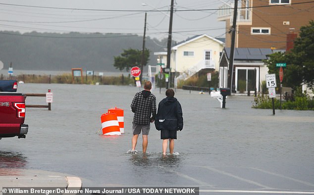 People wade up Read Avenue in Dewey Beach as Tropical Storm Ophelia hits the Delaware coast late Saturday afternoon